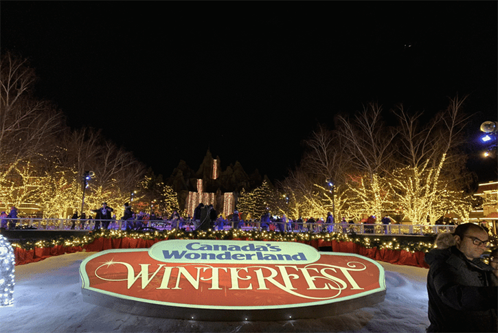The illuminated Winterfest sign shines brightly against the night sky, creating a festive atmosphere.